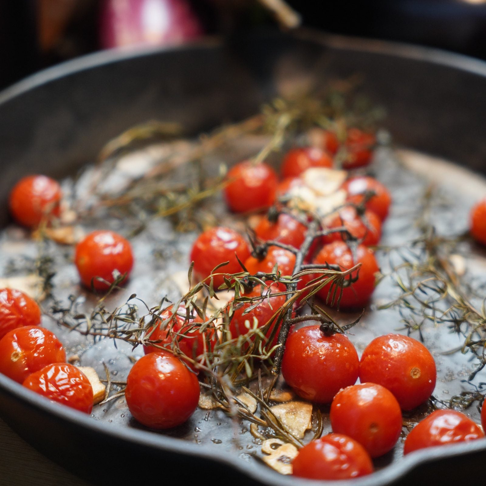 Hand sprinkling Bella Italia blend onto focaccia dough