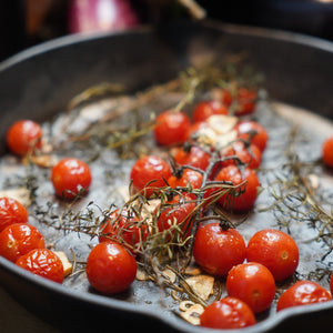 Hand sprinkling Bella Italia blend onto focaccia dough