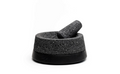 Molcajete in use on a rustic kitchen counter