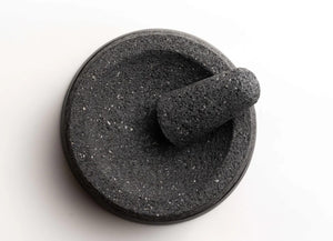 Whole spices ready to grind in a lava stone molcajete